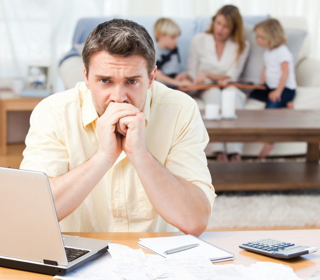 bigstock-Man-Calculating-His-Bills-Whil-11870153