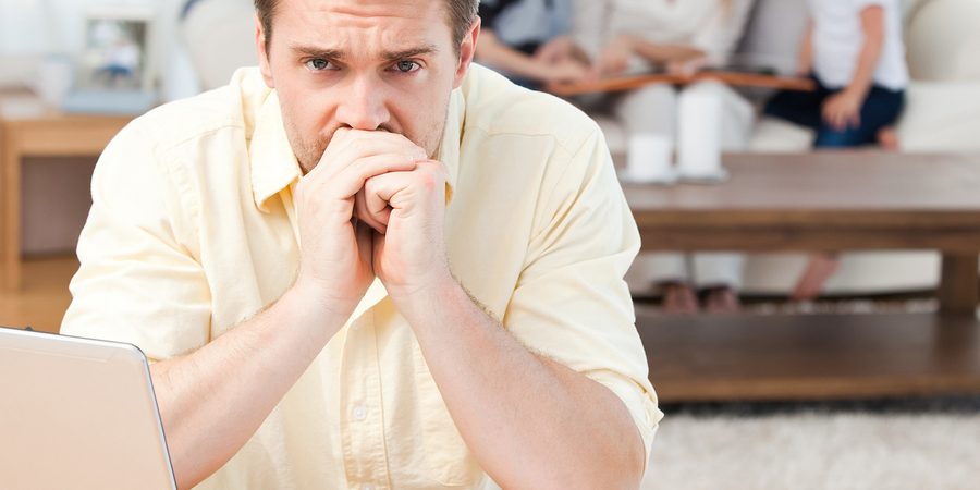 bigstock-Man-Calculating-His-Bills-Whil-11870153